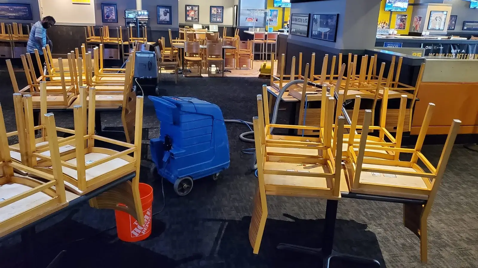 Professional commercial carpet cleaning in a restaurant with chairs raised and extraction equipment in use by KG Carpet and Upholstery Cleaning Corp.